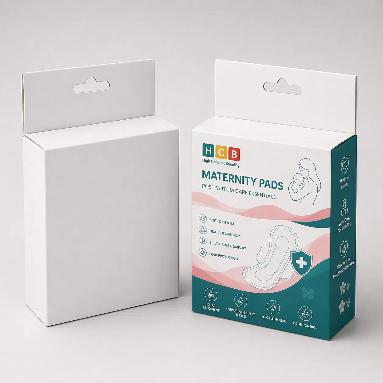 Two upright cardboard boxes, one plain white and one with pink floral maternity pad branding.